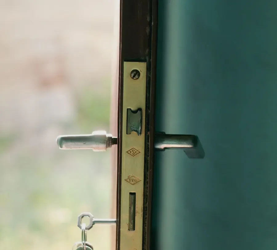 Door edge with a lock faceplate, lever handles and key – checking the multipoint mechanism before you change a uPVC door lock in Sheffield, Locksmith Sheffield guide