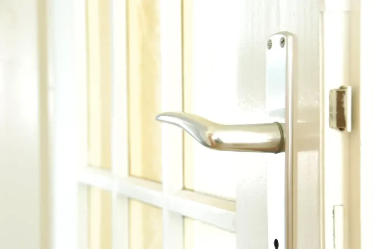 How to change a uPVC door lock in Sheffield – white door with a lever handle on a long backplate, Locksmith Sheffield guide to barrel, handle and multipoint replacement